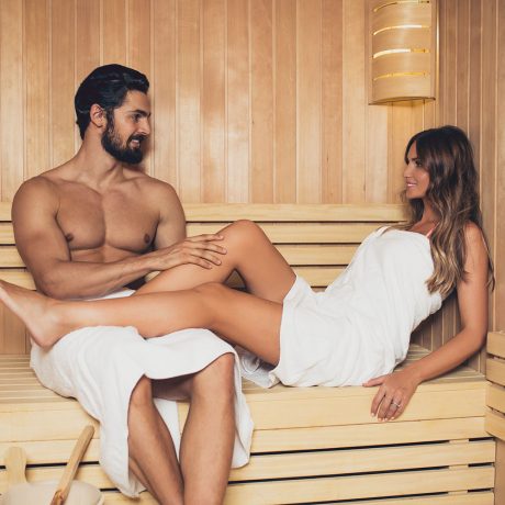 Beautiful couple relaxing in SPA sauna room.